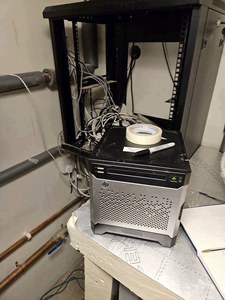 A dusty data cabinet and server in a boiler room